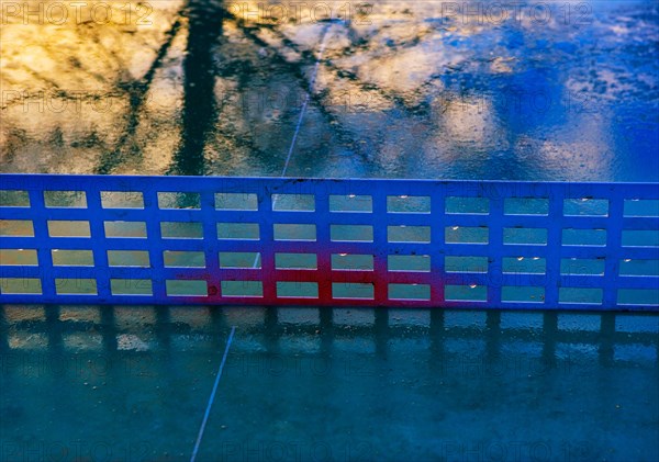 Reflection on a rain-wet table tennis table