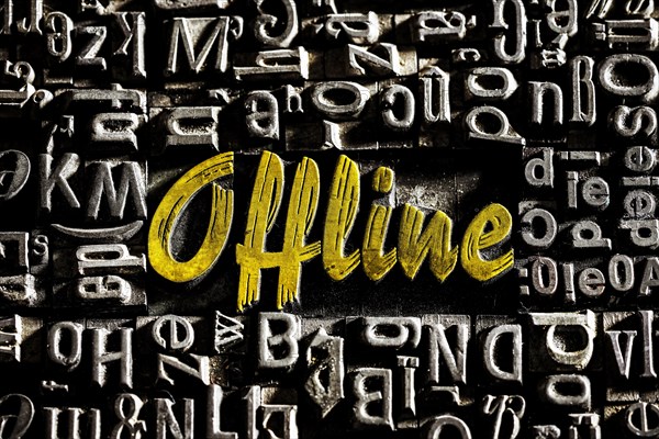 Old lead letters with golden writing show the word offline