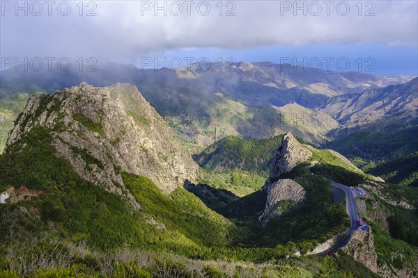 Mountains Roque de Ojila and Roque de la Zarcita with mountain road in Monumento Natural de los Roques