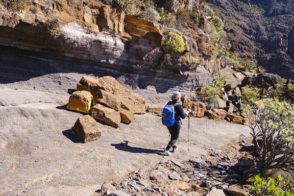 Woman hiking on rocky trail