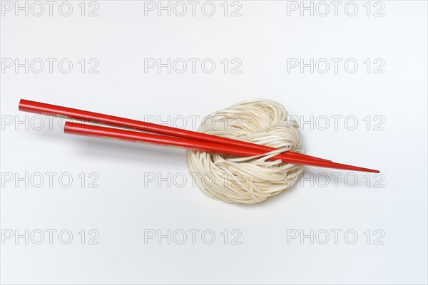 Asian nest noodles with red chopsticks