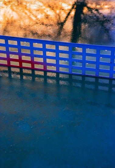 Reflection on a rain-wet table tennis table