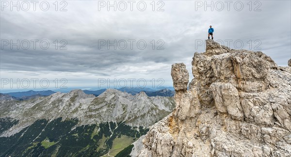 Mountaineer stands on a rock