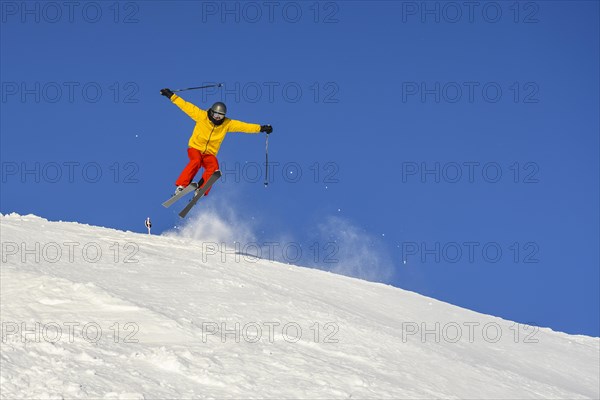 Skiers jumping on the ski slope