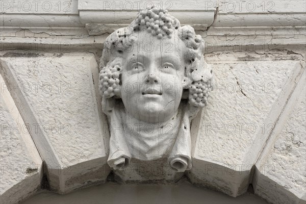 Head of a Bacchus above a gate