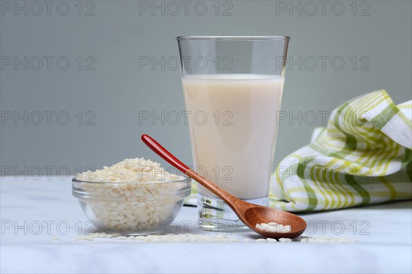 Rice milk in glass and rice grains