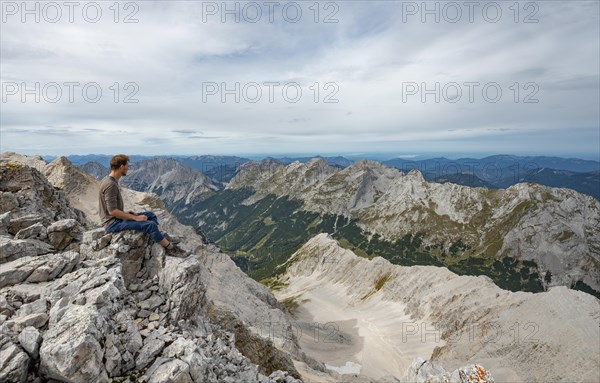 Hiker sitting at the summit of the Birkkarspitze