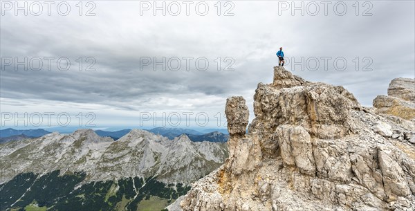 Mountaineer stands on a rock