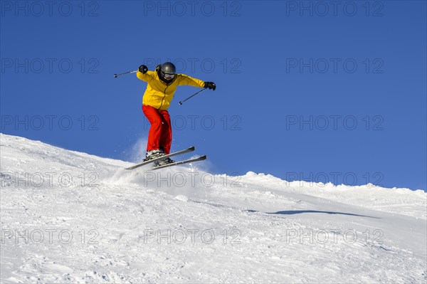 Skiers jumping on the ski slope