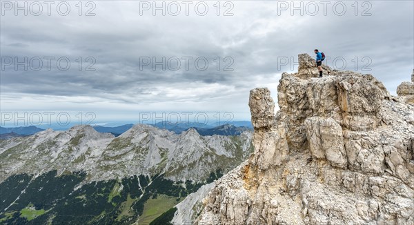 Mountaineer stands on a rock