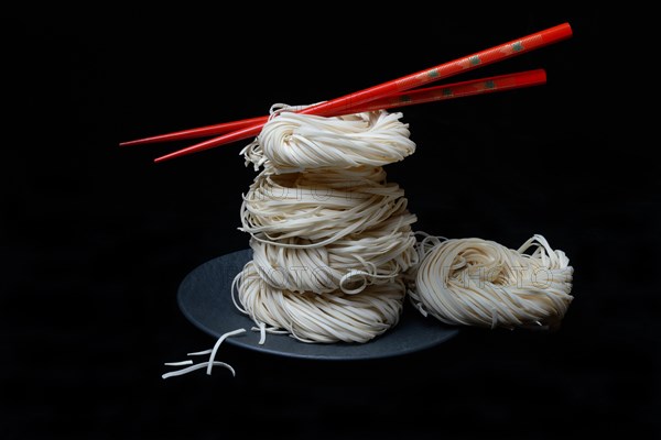 Asian nest noodles with red chopsticks