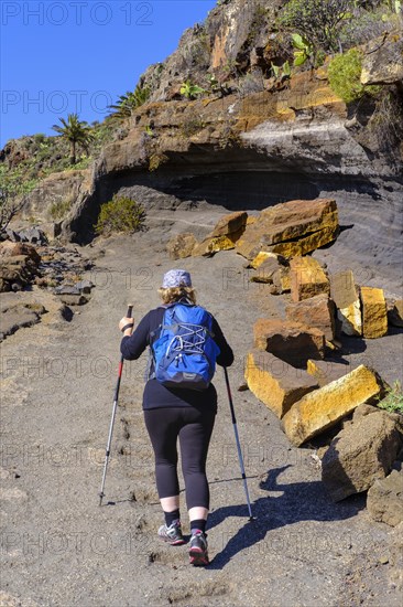 Woman hiking on rocky trail