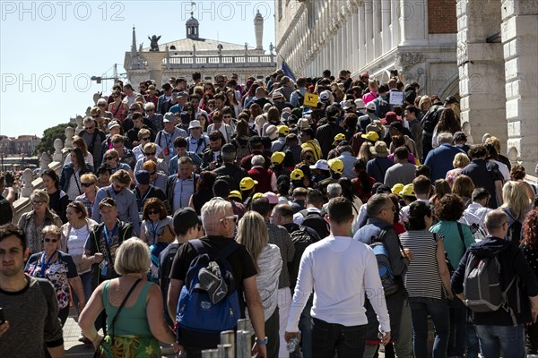 Tourists on the Ponte de Paglia visit the Bridge of Sighs