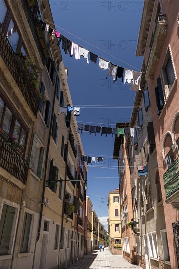 Laundry drying on clotheslines stretched between houses