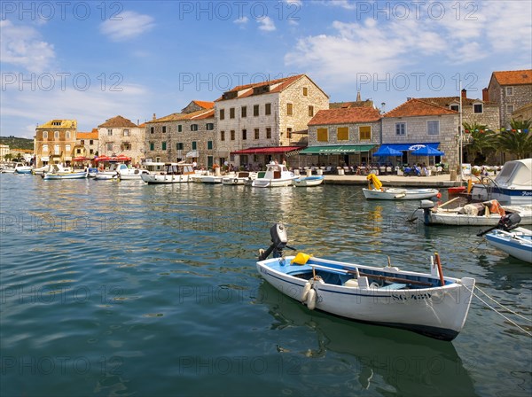 Promenade with fishing boats in the port