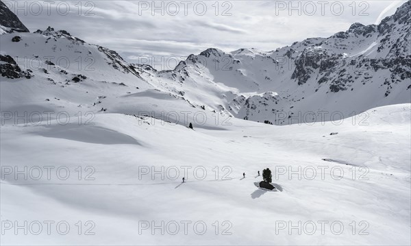 Ski tourers cross a flat slope