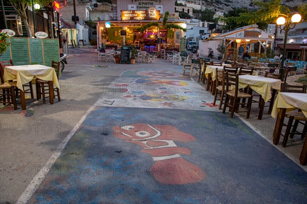 Colorful painted streets between shops and restaurants in the evening in Matala