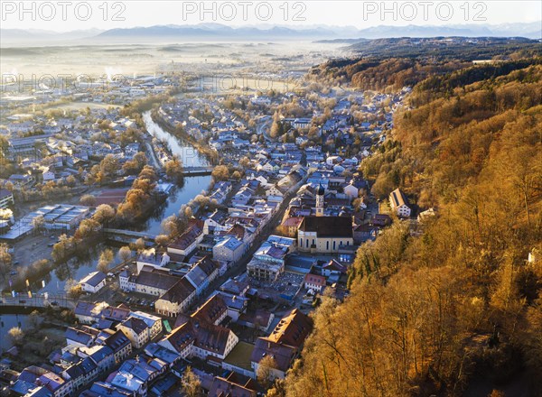 Old town Wolfratshausen with Loisach and mountain forest in winter