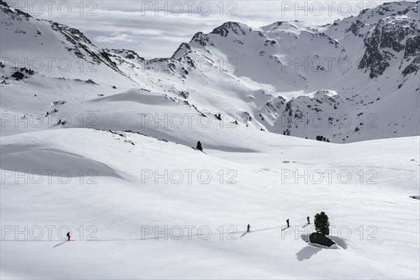 Ski tourers cross a flat slope