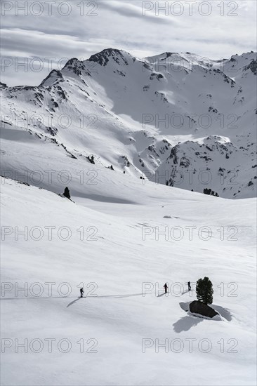 Ski tourers cross a flat slope