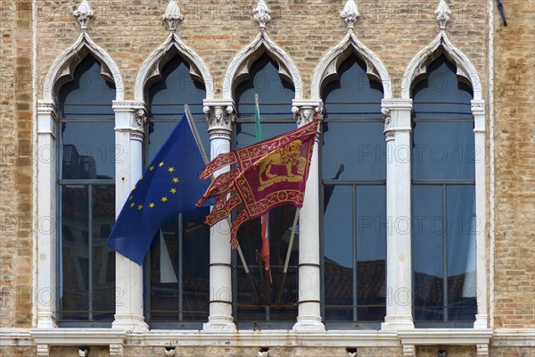 Waving flags of Europe and the Republic of Venice at Palazzo Zaguri