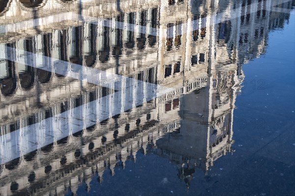 Reflection of the procurations at Acqua alta on St. Mark's Square