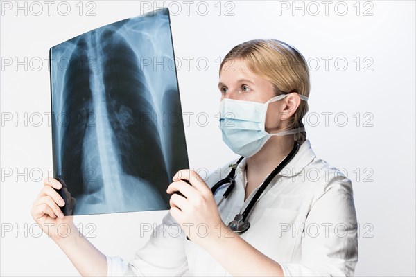 Doctor looks at X-ray image