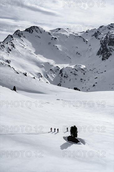 Ski tourers cross a flat slope