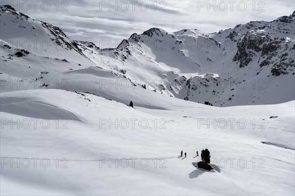 Ski tourers cross a flat slope