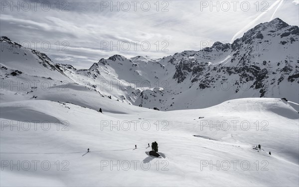 Ski tourers cross a flat slope