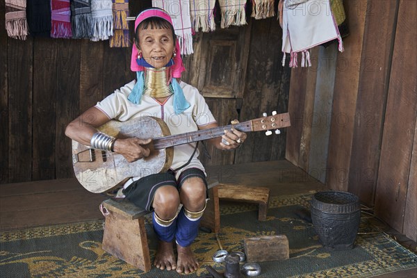 Folk group Padaung woman plays guitar and sings