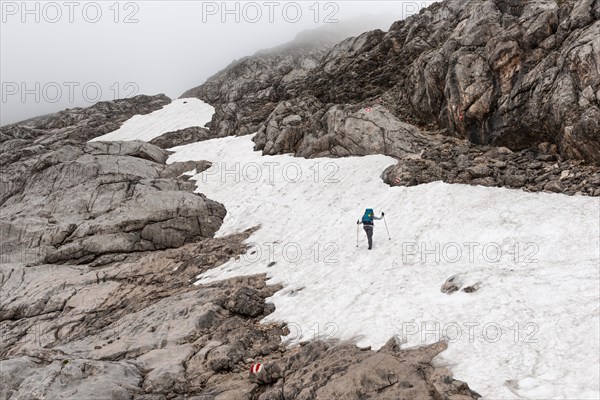 Mountaineer on marked route on snow field from Simonyhuette to Adamekhuette