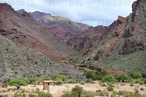 Lonely house in front of barren mountains