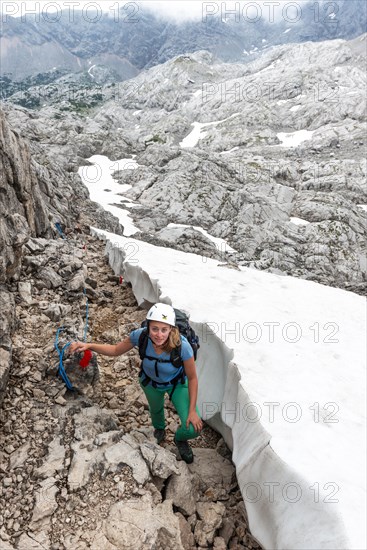 Mountaineer on secured route next to snow field from Simonyhuette to Adamekhuette