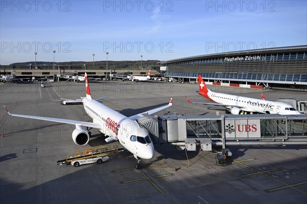 Zurich Airport with aircraft Swiss Airbus A220-300 HB-JCS and Helvetic Airways Embraer ERJ-190 HB-JVM