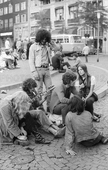 Hippies playing guitar on Dam Square