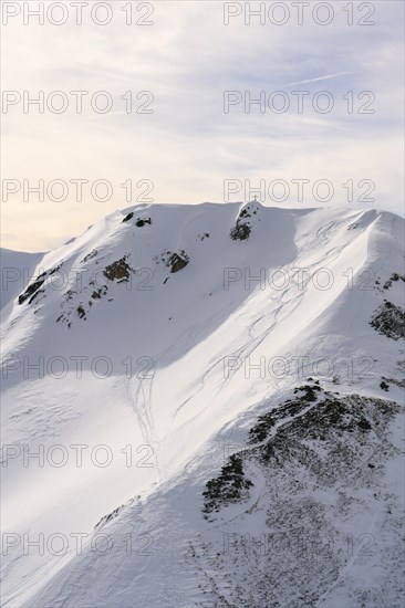 Moelser Sonnenspitze with ski tracks and summit cross