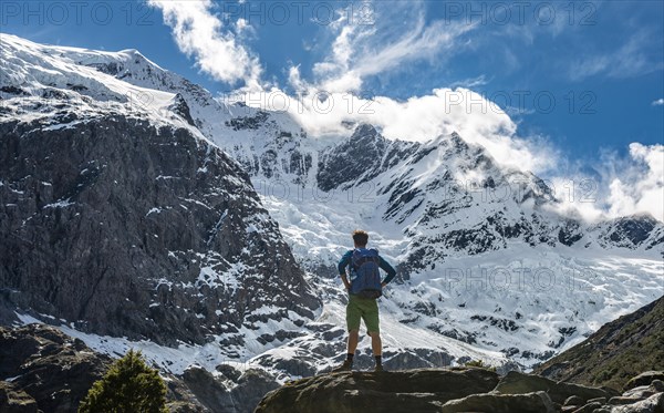 Mountaineer stands on rocks