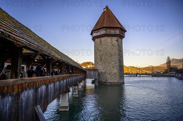 View over the river Reuss to the Chapel Bridge and Water Tower in the evening light