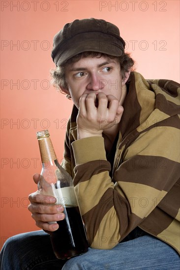 Teenager drinking alcohol from a bottle