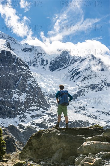 Mountaineer stands on rocks