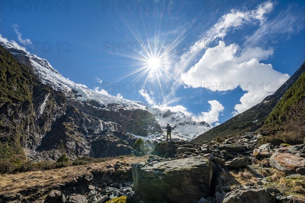 Mountaineer stands on rocks