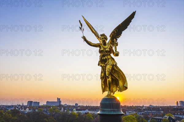 Golden angel of peace at sunrise