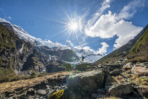 Mountaineer stands on rocks