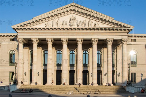 People sunbathe on columns of the staircase to the Bavarian State Opera