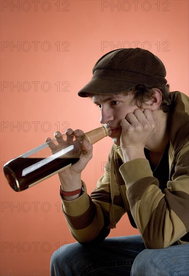 Teenager drinking alcohol from a bottle