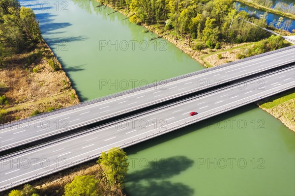 Lonely red car on motorway bridge of the motorway A8 over the river Inn