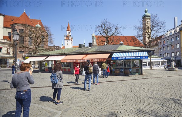 Queue of people with a safe distance in front of food stalls at Viktualienmarkt