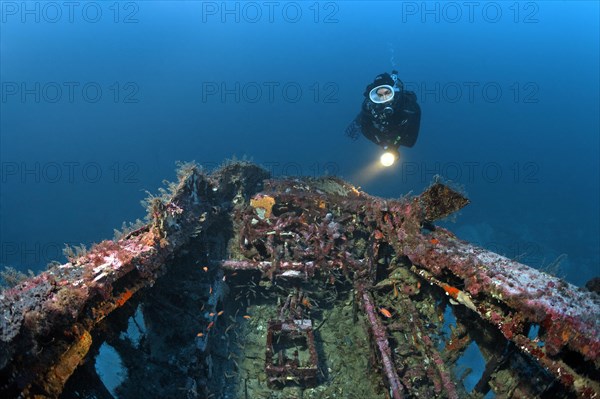 Diver views cockpit at aircraft wreck