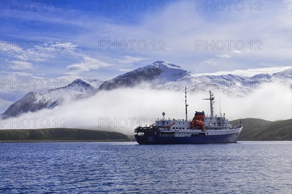 Expedition ship anchored in the port of Undine Harbour Bay